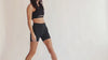 Women wearing the Embodie Renew Short while moving to showcase its supportive everyday fit.